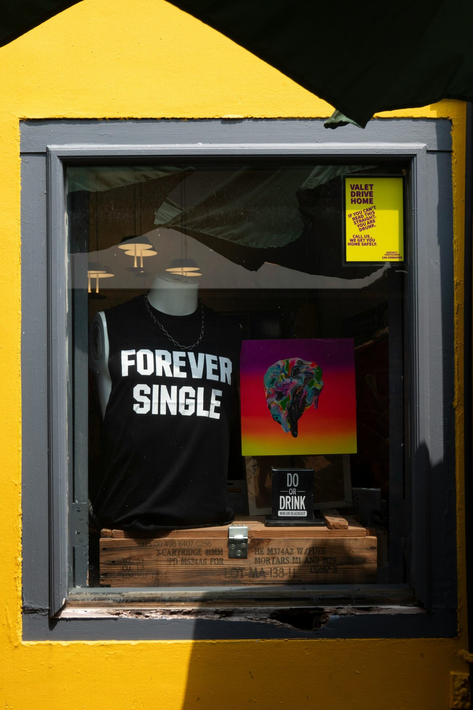 a t - shirt is displayed in a window of a store